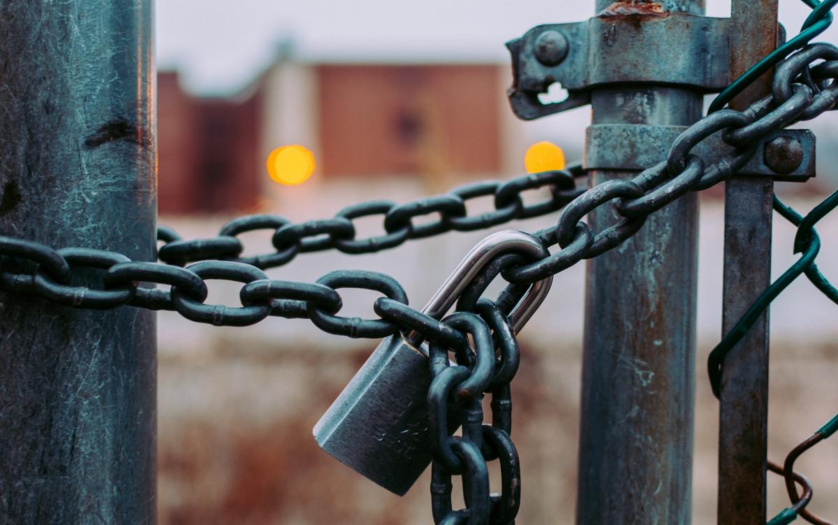 Fence closed with a padlock.