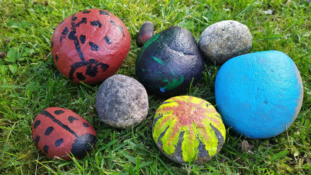 Painted garden rocks on grass